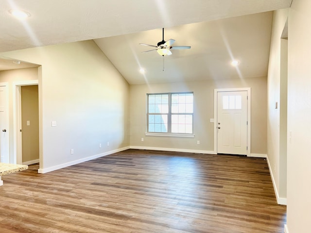 unfurnished living room with hardwood / wood-style floors, vaulted ceiling, and ceiling fan