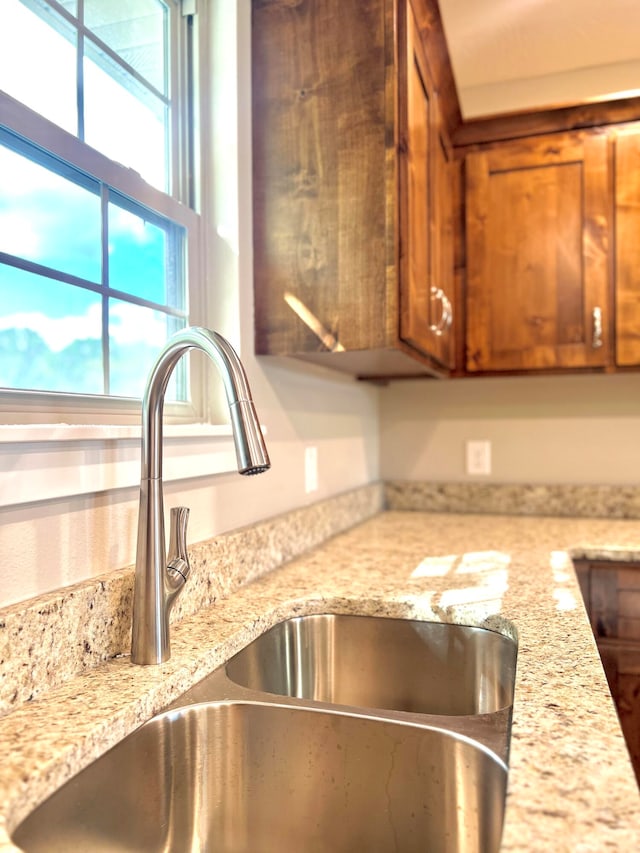 room details with light stone counters and sink