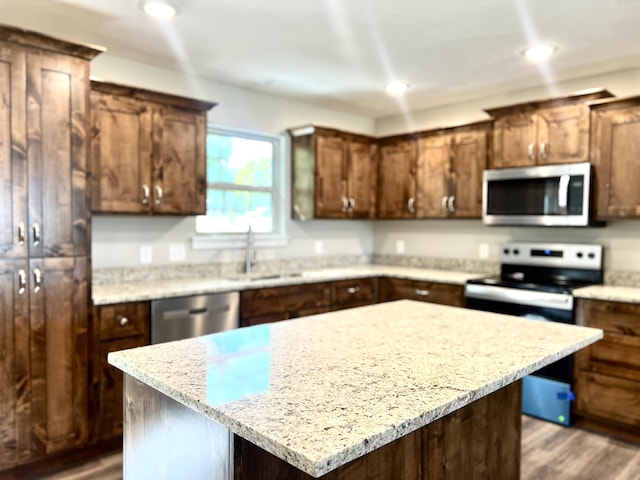 502 James, Billings, MO 65610 - kitchen with recessed lighting, wood finished floors, a center island, and stainless steel appliances