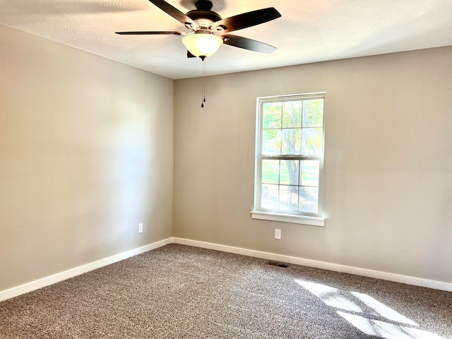 empty room with carpet and ceiling fan