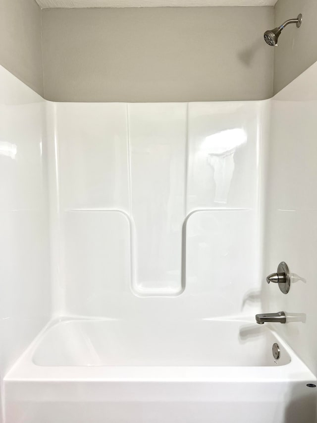 bathroom with shower / washtub combination