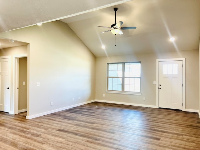 unfurnished living room featuring lofted ceiling, ceiling fan, and light hardwood / wood-style floors