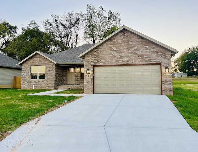 502 James, Billings, MO 65610 - single story home featuring a front lawn, brick siding, driveway, and an attached garage