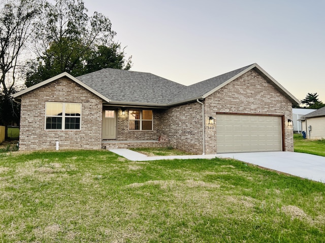 502 James, Billings, MO 65610 - ranch-style home with an attached garage, driveway, brick siding, and a front yard
