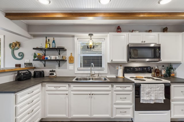 kitchen featuring white electric range oven, dark countertops, stainless steel microwave, white cabinets, and a sink