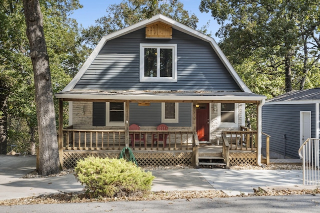 dutch colonial with covered porch and a gambrel roof
