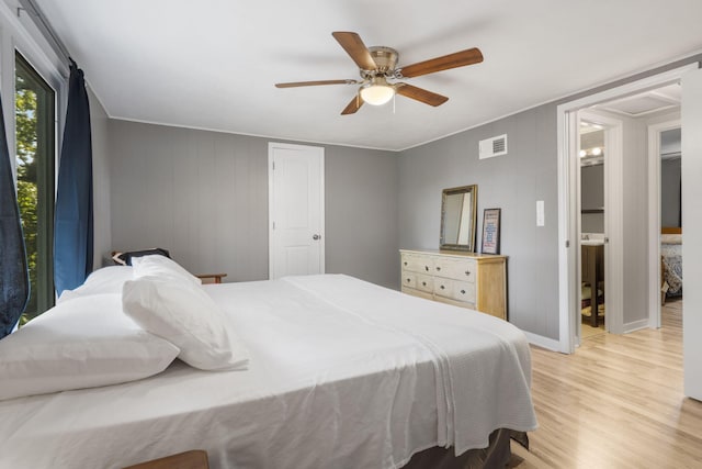 bedroom with light wood-type flooring, visible vents, ceiling fan, and baseboards