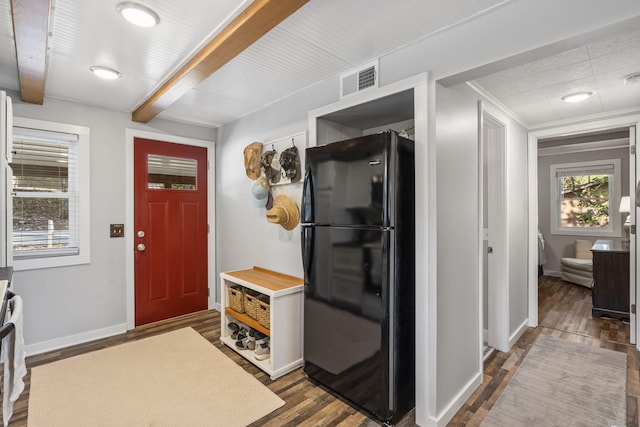 entryway featuring visible vents, beam ceiling, baseboards, and dark wood-style flooring