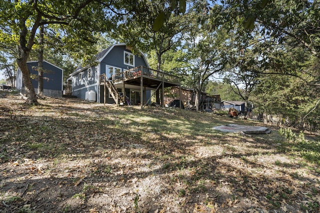 back of house with stairs and a deck