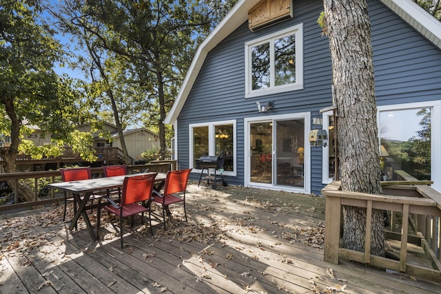 wooden terrace featuring outdoor dining area