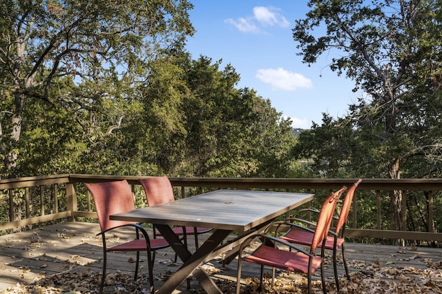 wooden terrace with outdoor dining area