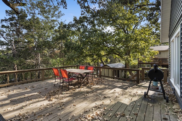 wooden deck featuring outdoor dining area