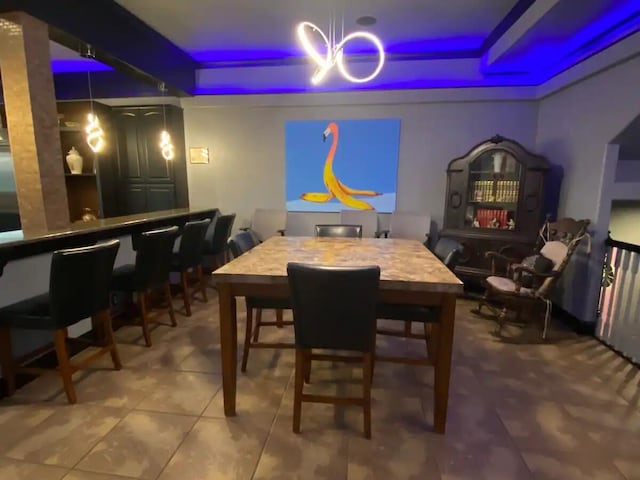 dining space featuring a notable chandelier and tile patterned flooring