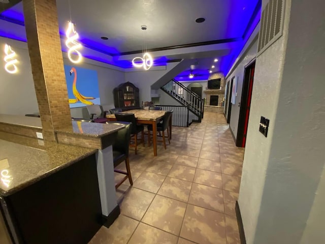 playroom with tile patterned flooring and a raised ceiling