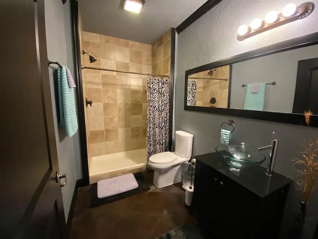 bathroom featuring a shower with curtain, vanity, tile patterned flooring, and toilet