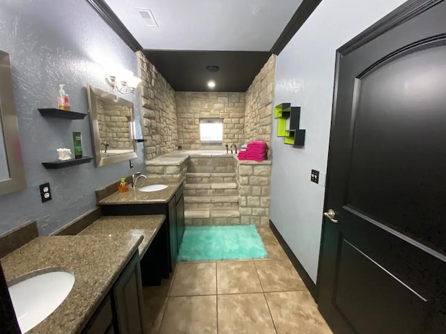 bathroom featuring crown molding, tile patterned floors, a tub to relax in, and vanity