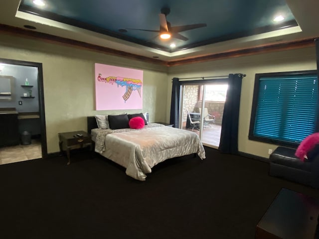 tiled bedroom with ceiling fan, a tray ceiling, and ornamental molding