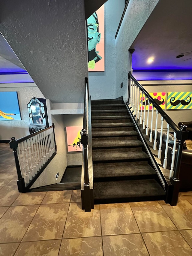 stairway with tile patterned floors