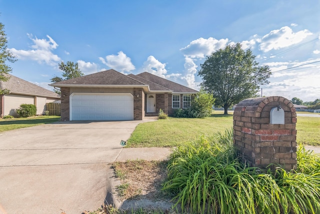 single story home featuring a garage and a front lawn