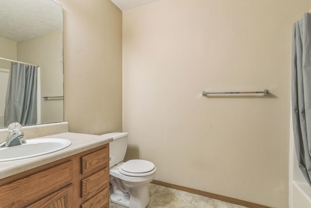 bathroom featuring a textured ceiling, tile patterned floors, vanity, and toilet