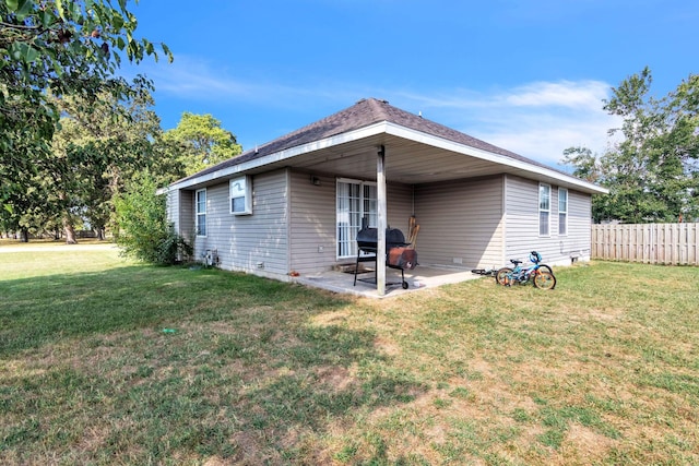 back of house with a yard and a patio