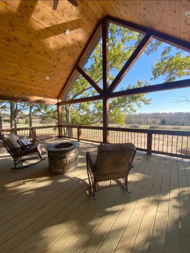 wooden deck featuring a rural view and a fire pit