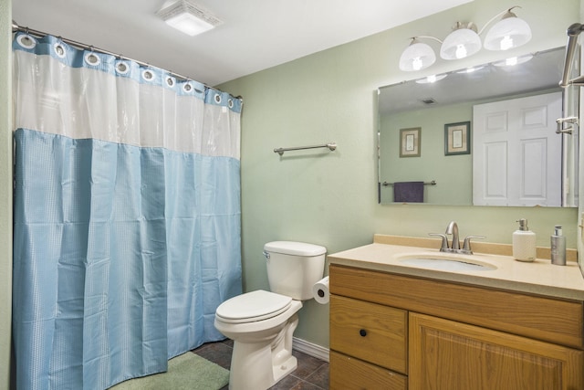 bathroom featuring tile patterned flooring, curtained shower, vanity, and toilet