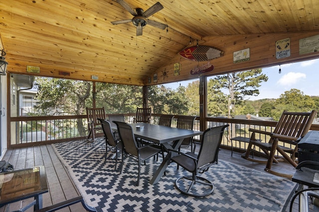 sunroom with ceiling fan, vaulted ceiling with beams, and wooden ceiling