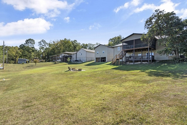 view of yard with an outdoor fire pit and a wooden deck