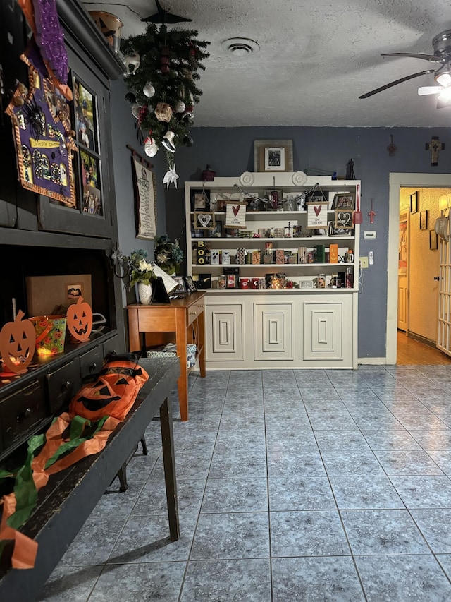 10603 N Main St, Butterfield, MO 65625 - tiled dining room with a textured ceiling, ceiling fan, and visible vents