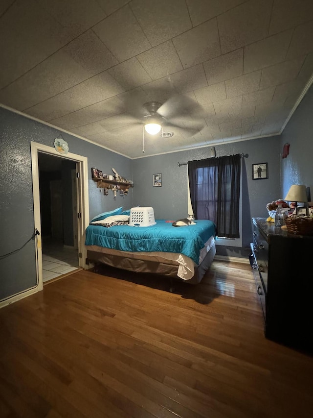 10603 N Main St, Butterfield, MO 65625 - bedroom featuring wood finished floors, crown molding, a textured wall, and ceiling fan