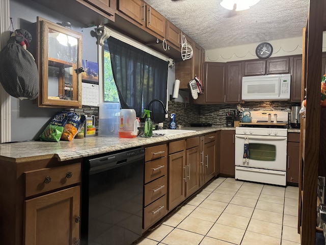 10603 N Main St, Butterfield, MO 65625 - kitchen with light countertops, light tile patterned floors, a sink, white appliances, and decorative backsplash