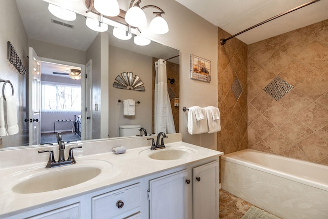 full bathroom featuring shower / bath combo with shower curtain, vanity, and toilet