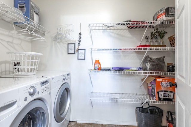 clothes washing area with washer and clothes dryer