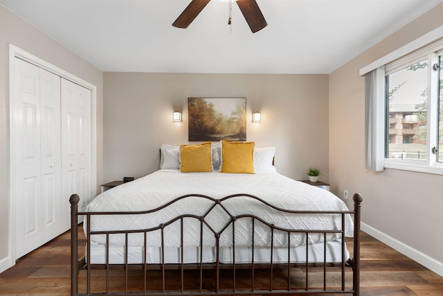 bedroom featuring dark wood-type flooring, a closet, and ceiling fan