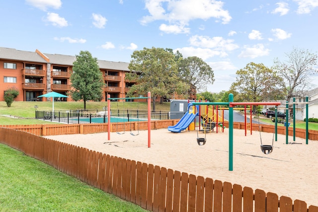 view of play area featuring a pool and a lawn