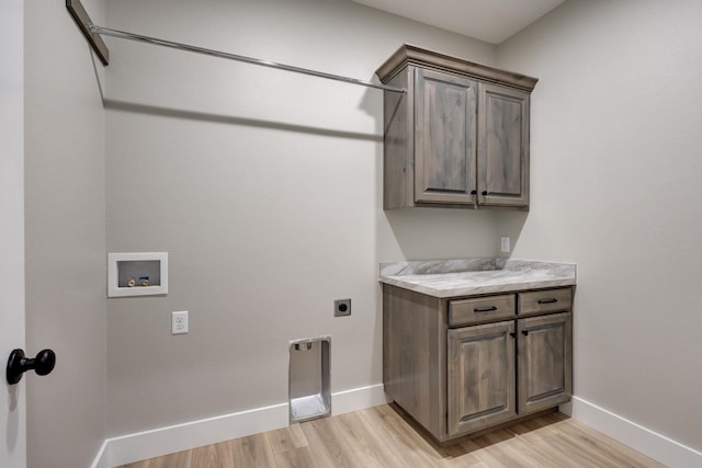 laundry area featuring cabinets, hookup for an electric dryer, washer hookup, and light wood-type flooring