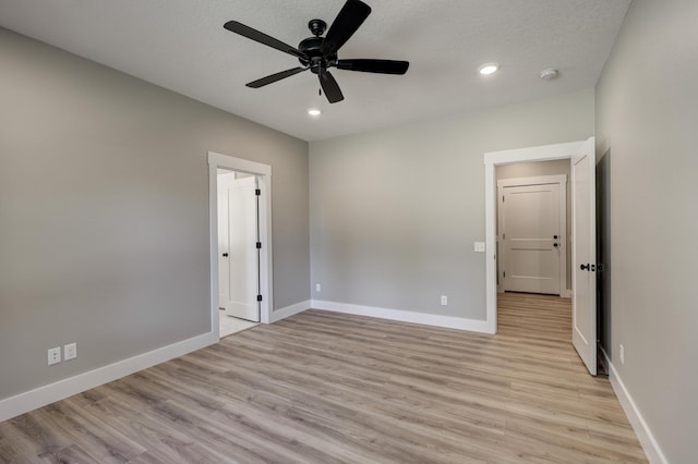 unfurnished bedroom with ceiling fan, a textured ceiling, and light hardwood / wood-style floors