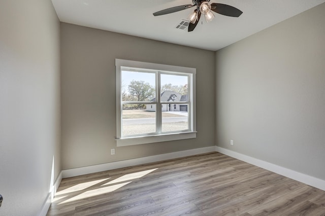 empty room with light hardwood / wood-style flooring and ceiling fan