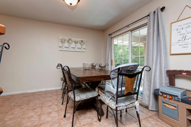 dining space featuring light tile patterned floors