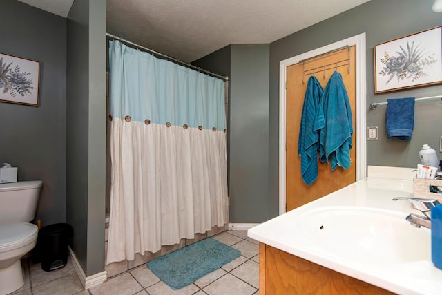 bathroom featuring a shower with curtain, a textured ceiling, vanity, tile patterned floors, and toilet