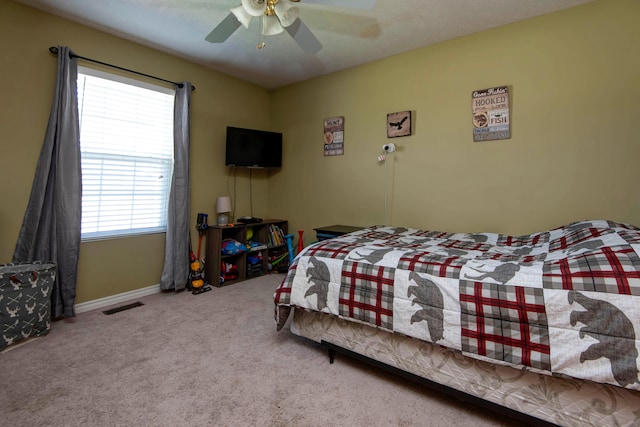 bedroom with multiple windows, carpet flooring, and ceiling fan