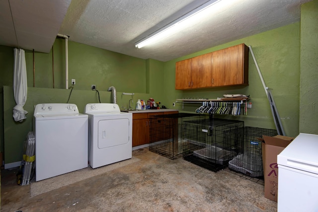 laundry area featuring cabinets and washer and clothes dryer