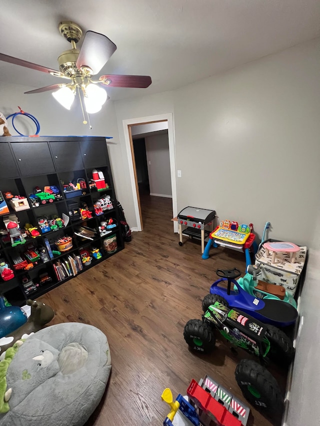 playroom with wood-type flooring and ceiling fan