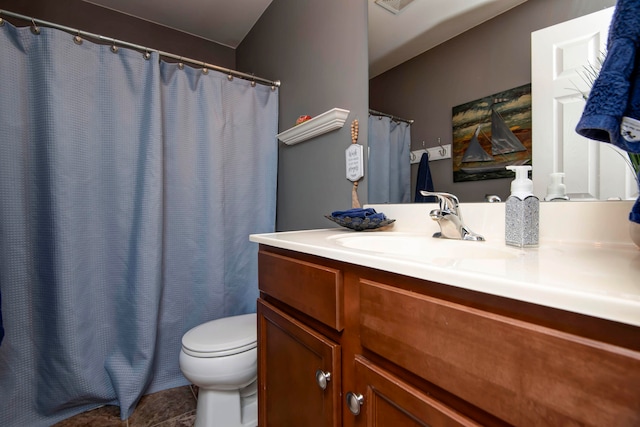 bathroom featuring tile patterned flooring, vanity, and toilet