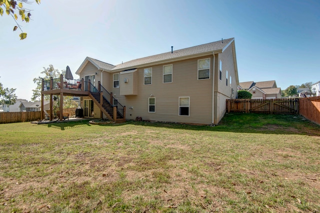 rear view of property with a lawn and a deck