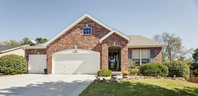 view of front property with a garage and a front yard