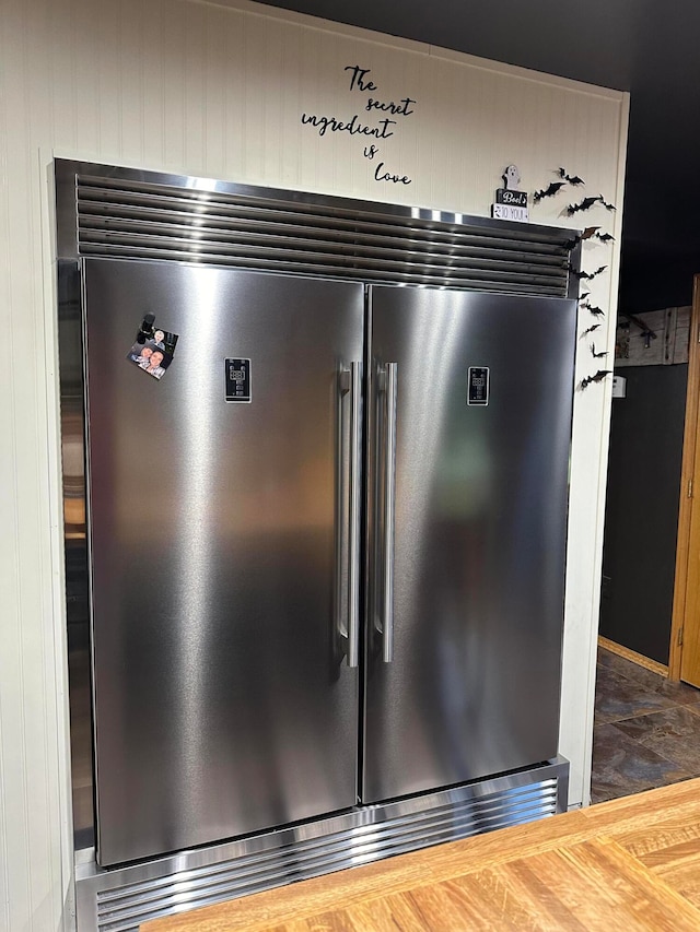 interior details featuring stainless steel built in refrigerator and butcher block countertops