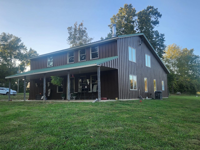 7020 N Farm Road 69, Walnut Grove, MO 65770 - rear view of house with central AC, a patio area, board and batten siding, a yard, and metal roof