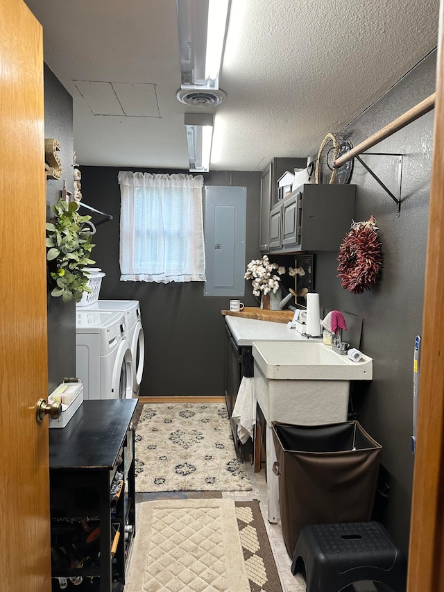 laundry room featuring electric panel and washer and dryer